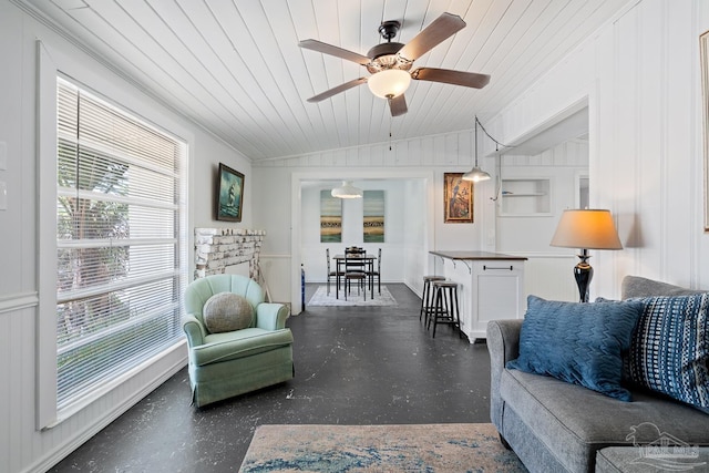 living area featuring wood ceiling, a ceiling fan, and vaulted ceiling