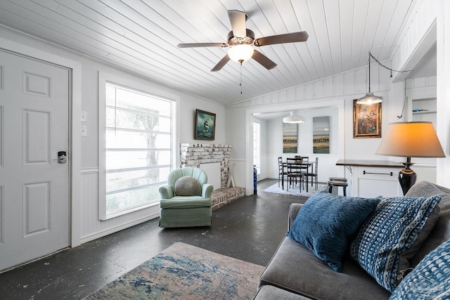 living area with ceiling fan, plenty of natural light, wood ceiling, and lofted ceiling