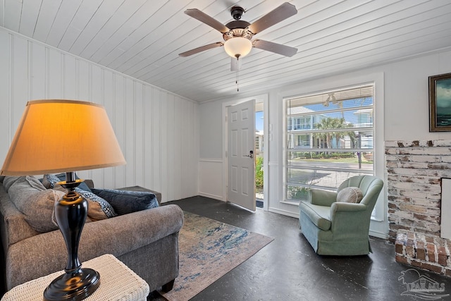 living room with crown molding, concrete flooring, ceiling fan, and wooden ceiling
