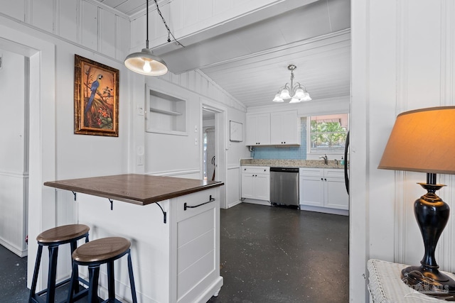 kitchen with dark countertops, a notable chandelier, a breakfast bar, white cabinetry, and stainless steel dishwasher