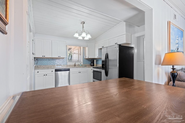 kitchen with pendant lighting, tasteful backsplash, an inviting chandelier, stainless steel appliances, and white cabinetry