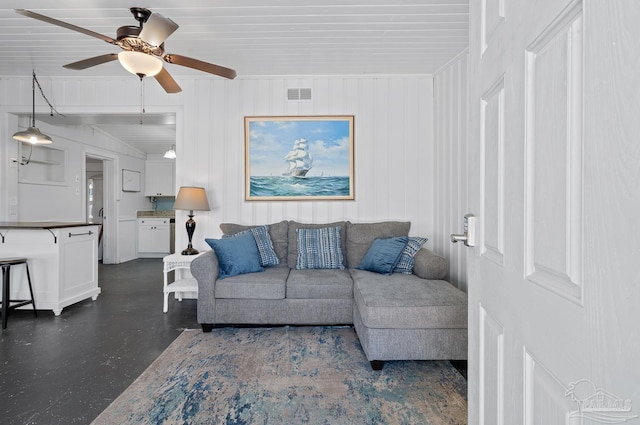 living room with a ceiling fan and visible vents