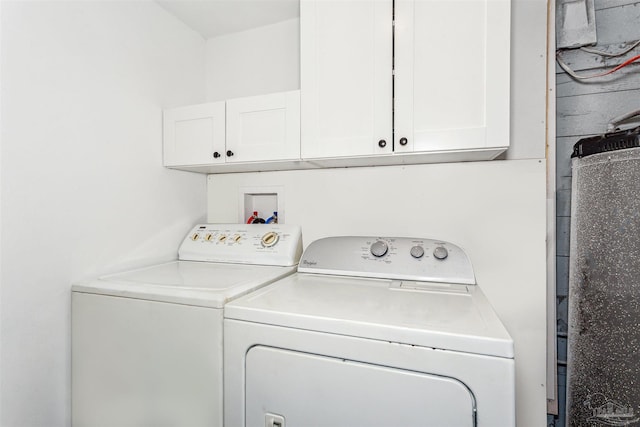 laundry area with washing machine and dryer and cabinets