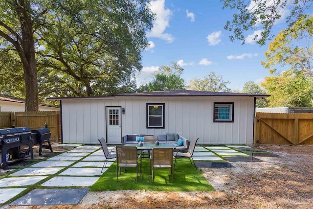 rear view of property featuring an outdoor hangout area and a patio area