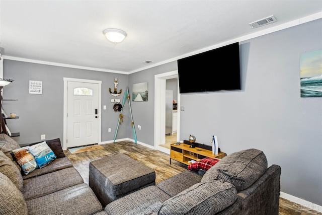 living room featuring crown molding and hardwood / wood-style floors