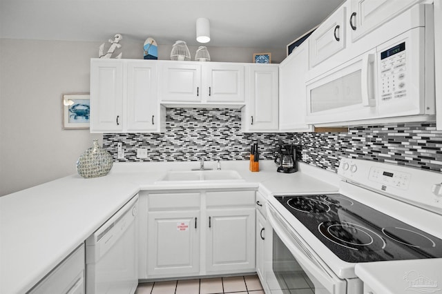 kitchen with white cabinetry, sink, white appliances, and backsplash