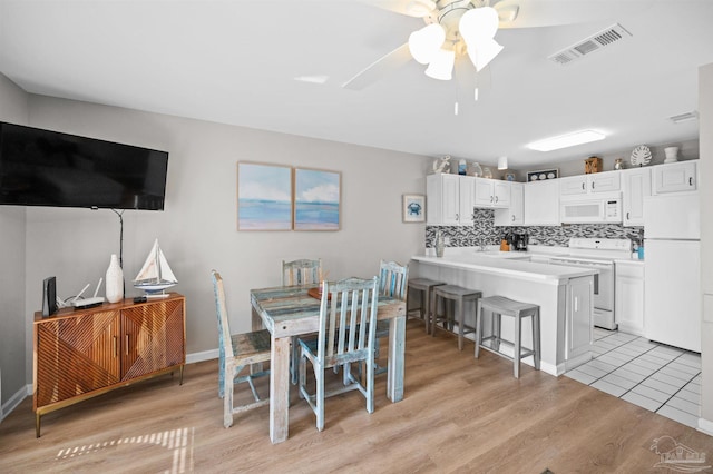 dining area featuring light hardwood / wood-style flooring and ceiling fan