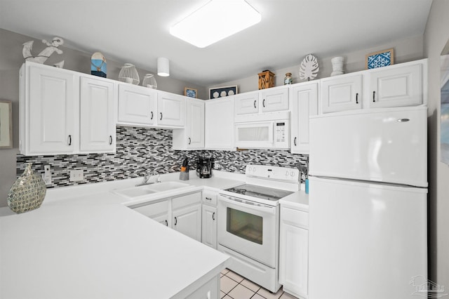 kitchen with white cabinetry, sink, backsplash, light tile patterned floors, and white appliances