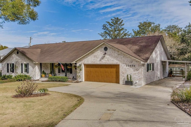 view of front of property with a carport, a garage, and a front yard