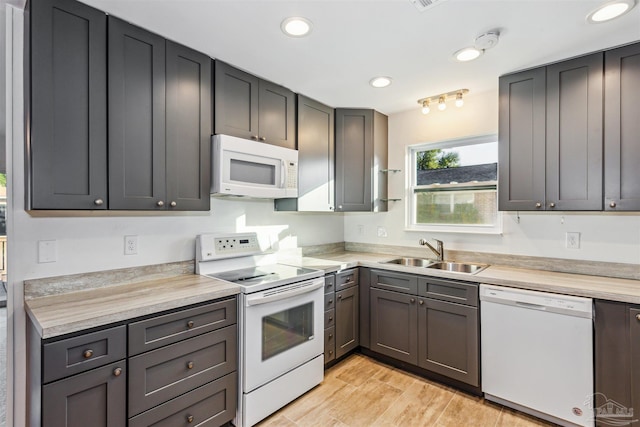 kitchen featuring sink and white appliances