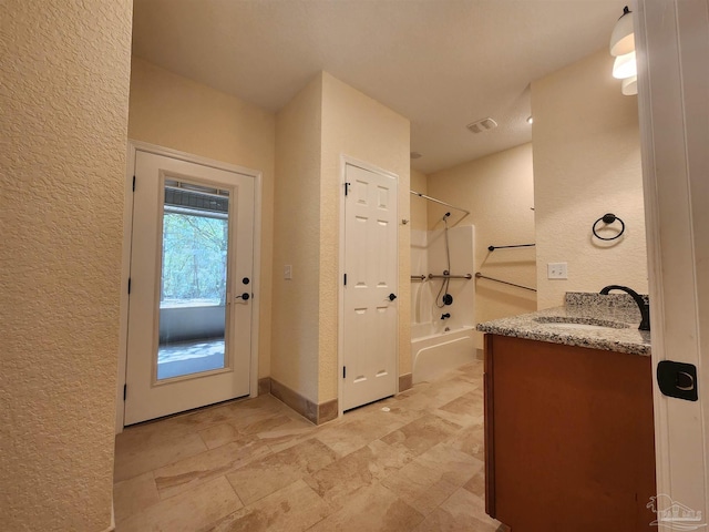 bathroom with vanity and bathing tub / shower combination