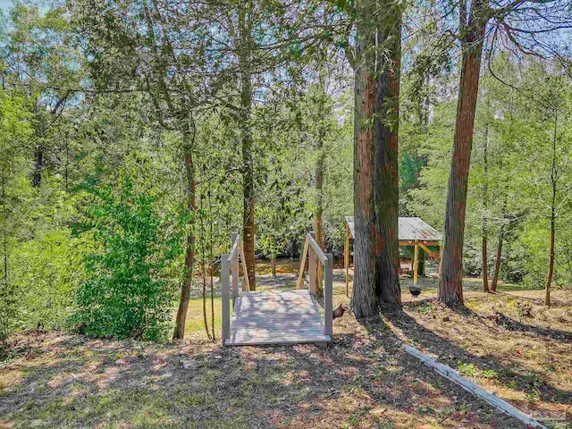 view of yard with a view of trees