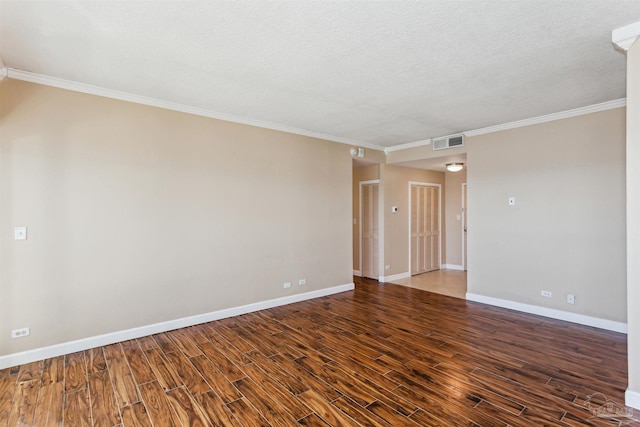 spare room with dark hardwood / wood-style flooring, a textured ceiling, and ornamental molding