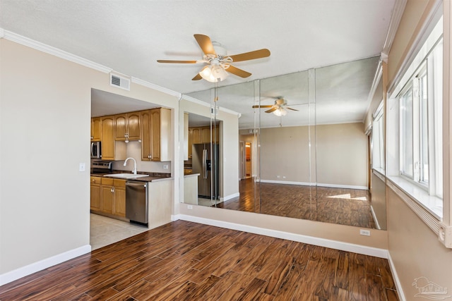 interior space with ceiling fan, sink, light hardwood / wood-style flooring, crown molding, and a textured ceiling