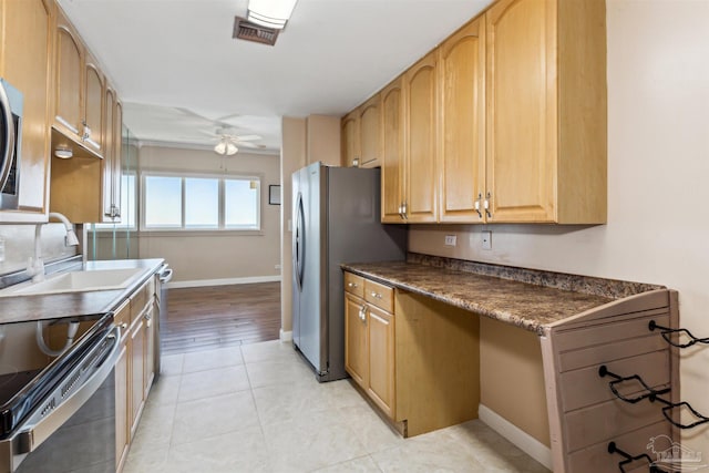 kitchen featuring sink, ceiling fan, light wood-type flooring, appliances with stainless steel finishes, and light brown cabinetry