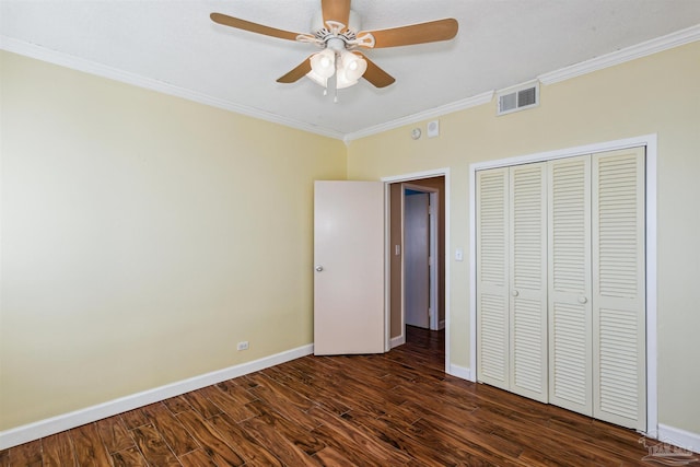 unfurnished bedroom with ceiling fan, dark hardwood / wood-style floors, ornamental molding, and a closet