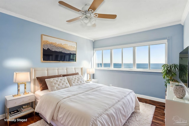 bedroom with ceiling fan, dark hardwood / wood-style flooring, and crown molding