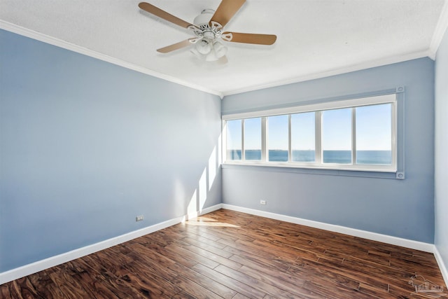 spare room with a wealth of natural light, crown molding, ceiling fan, and dark hardwood / wood-style floors