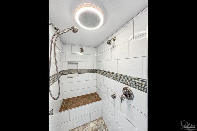 bathroom featuring tiled shower