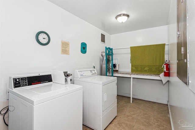 washroom featuring independent washer and dryer and light tile patterned floors