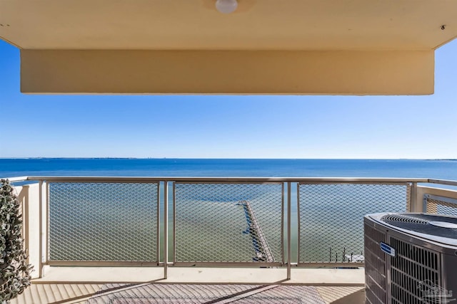 balcony with a water view and central air condition unit