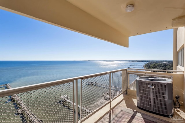 balcony featuring a water view and central AC unit