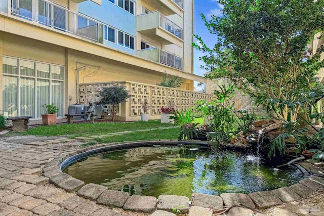 view of home's community with a small pond