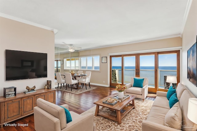 living room featuring crown molding, plenty of natural light, a water view, and wood-type flooring