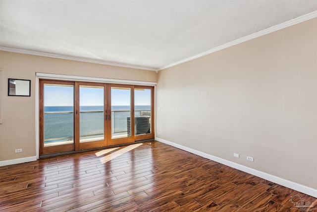 unfurnished room featuring dark hardwood / wood-style flooring, a water view, and crown molding