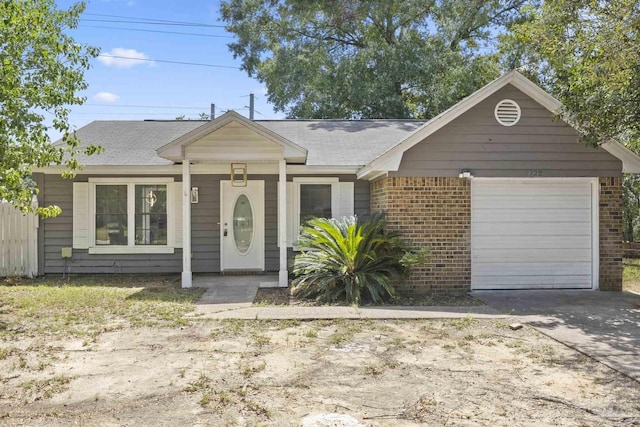 view of front of home with a garage, brick siding, and concrete driveway