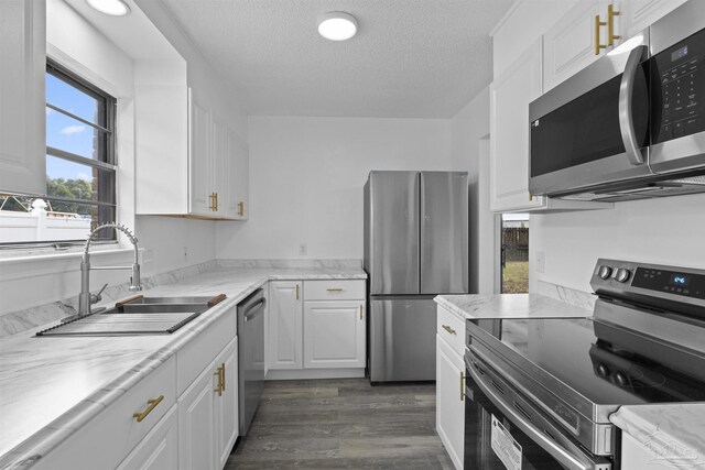 spare room featuring a textured ceiling, baseboards, and wood finished floors