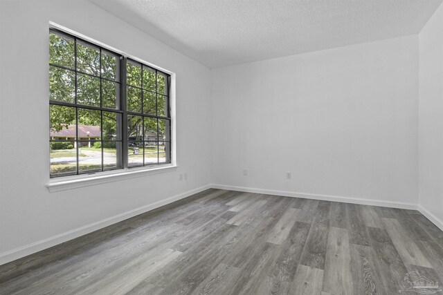 empty room with wood finished floors, baseboards, and ceiling fan