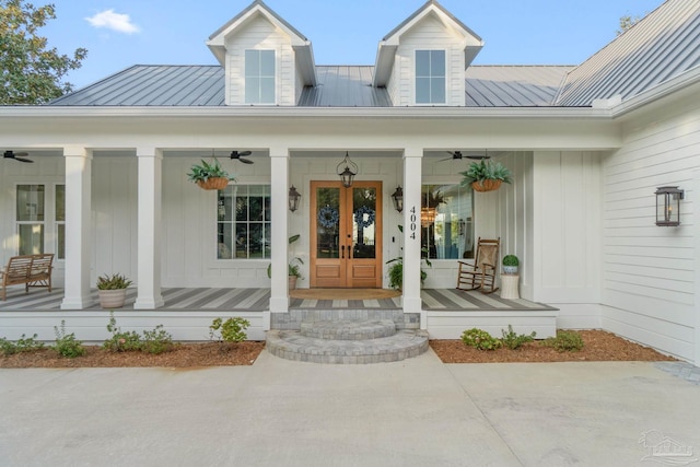 doorway to property featuring french doors, covered porch, and ceiling fan