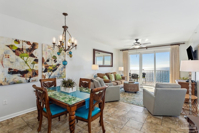 dining space with ceiling fan with notable chandelier