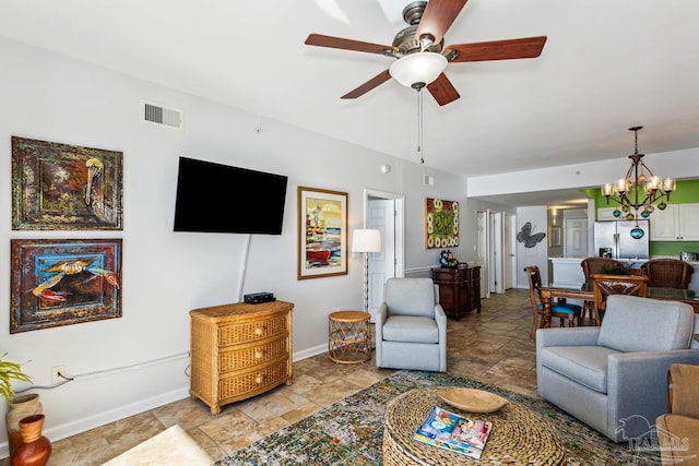 living room featuring ceiling fan with notable chandelier