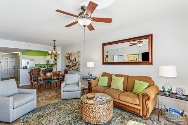 living room with ceiling fan with notable chandelier