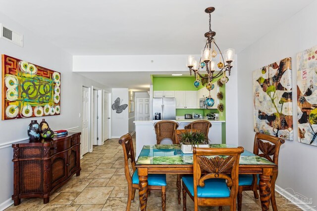 dining space with an inviting chandelier