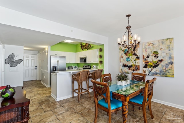 dining area featuring a notable chandelier