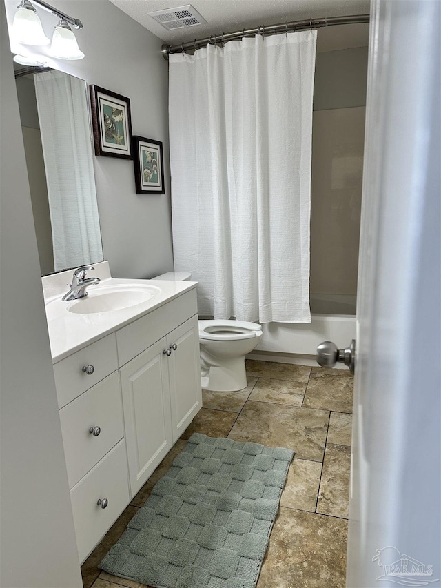 full bathroom featuring shower / tub combo, vanity, and toilet