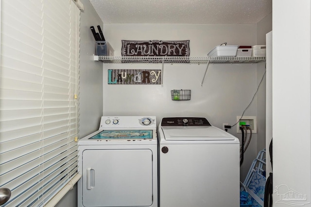 clothes washing area with a textured ceiling and washing machine and clothes dryer