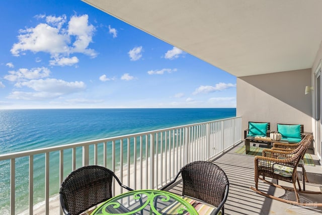 balcony featuring a water view and a view of the beach