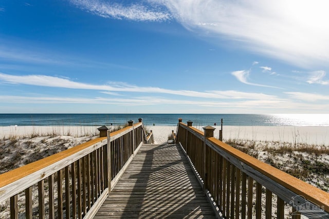 surrounding community featuring a water view and a beach view