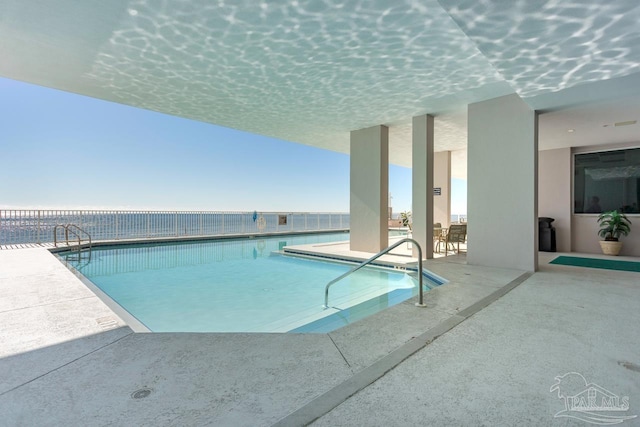 view of swimming pool featuring a patio area