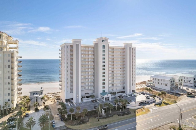 view of property featuring a beach view and a water view