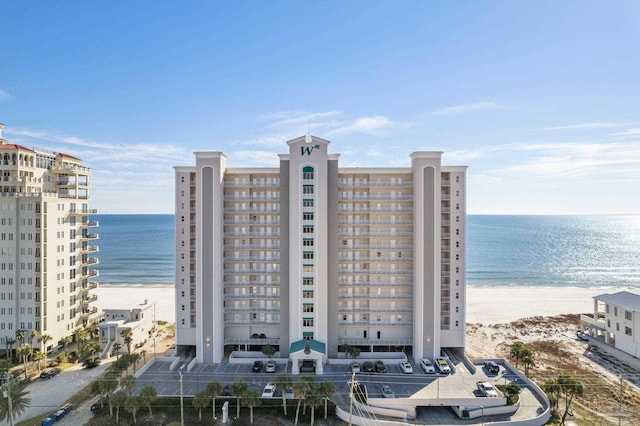 view of property featuring a water view and a view of the beach