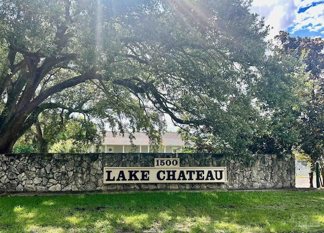 community / neighborhood sign with a lawn