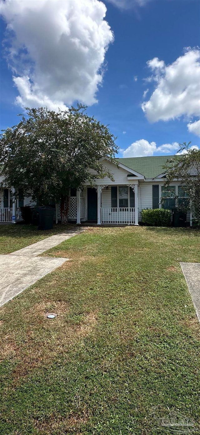 view of front of house with a front yard and a porch