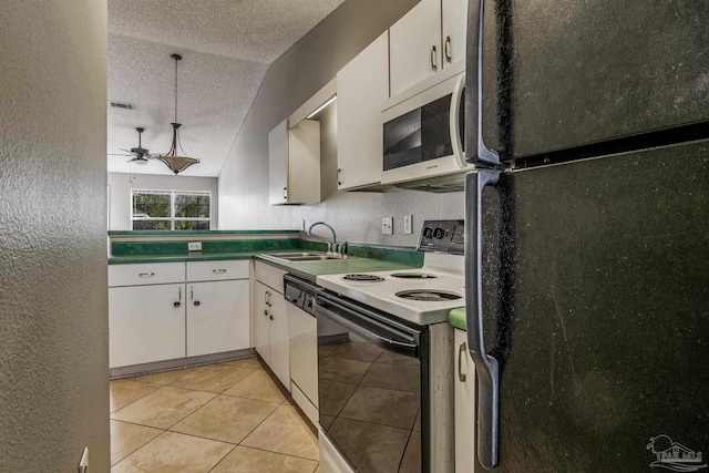 kitchen featuring white appliances, white cabinetry, vaulted ceiling, and sink