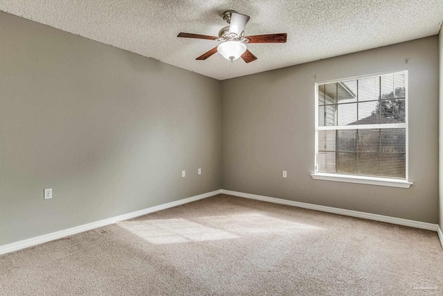 carpeted empty room with a textured ceiling and ceiling fan