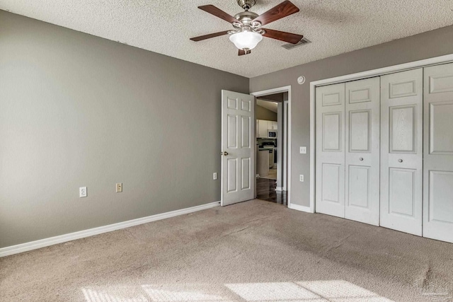 321 Loveland Cir, Pensacola, FL 32526 - unfurnished bedroom featuring carpet floors, a textured ceiling, baseboards, a closet, and a ceiling fan